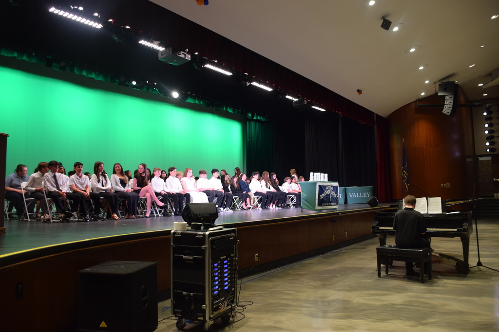 The 77 new inductees to the LVMS National Junior Honor Society listen on as Jack Kelly serenades the audience with Impromptu No. 2 in AB Major by Franz Schubert.