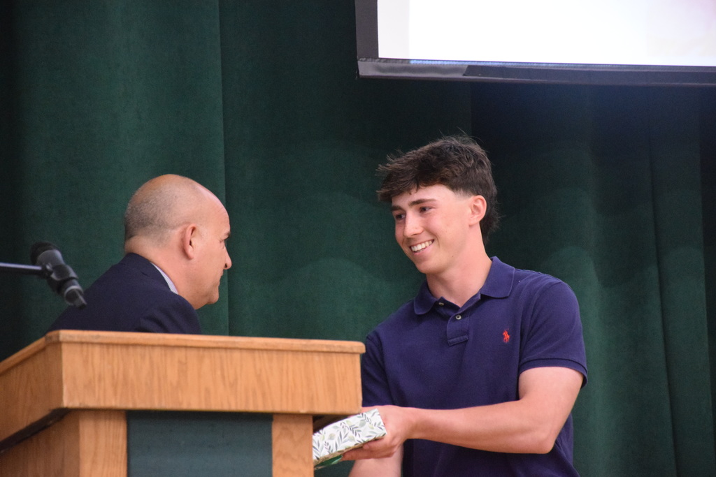 Liam Baker receives his recognition as a top 15 student at the 2026 ceremony.