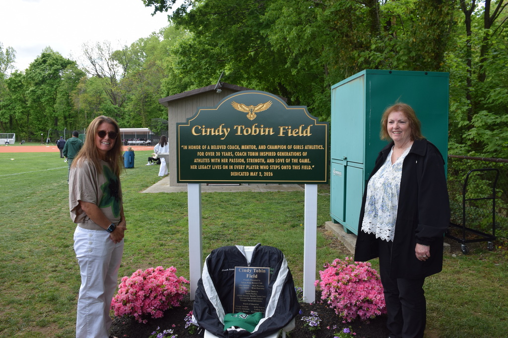 Nadine Pacifico and Wendy Tobin unveiled the sign commemorating the dedication of the Locust Valley High School softball field for legendary coach Cindy Tobin.