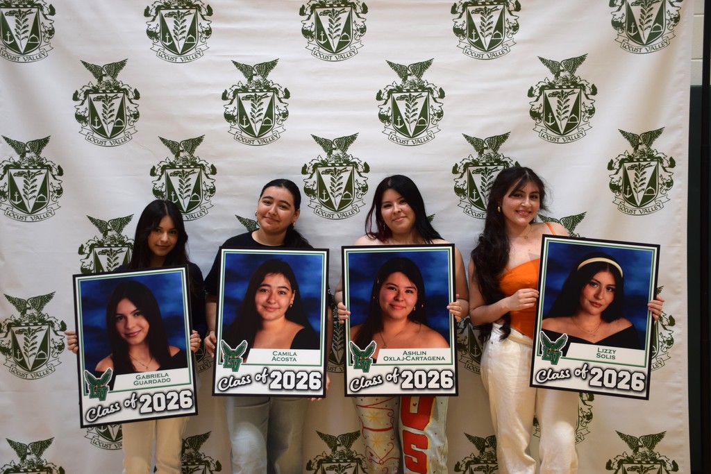 Seniors show off their signs from the Locust Valley High School Parents Council at Up & Away Day 2026.