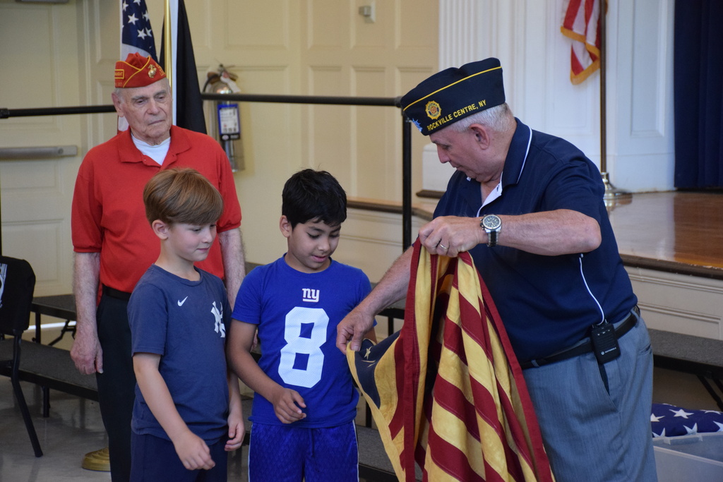 Bayville Intermediate School students handle a Betsy Ross flag.