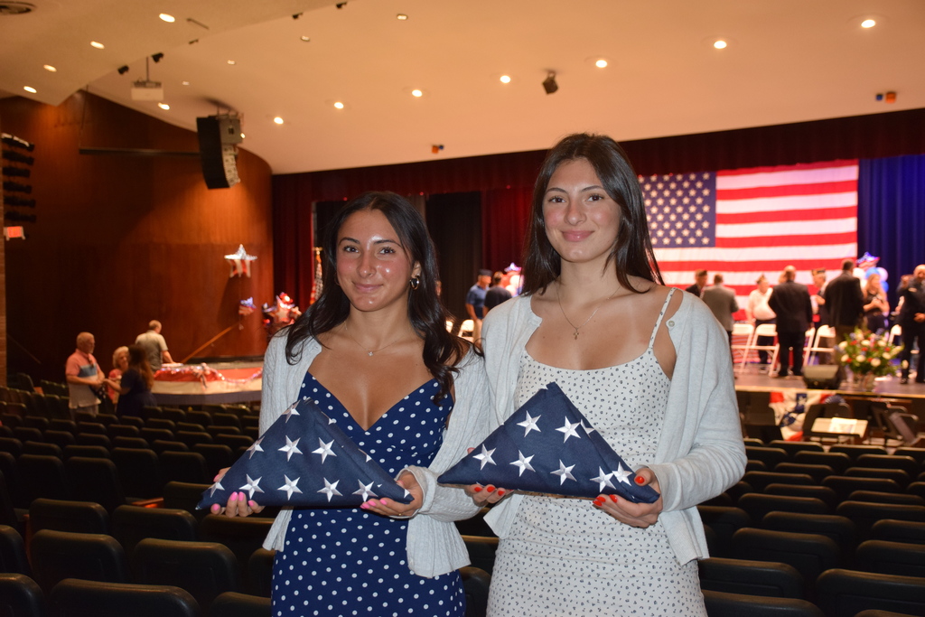Locust Valley High School seniors Cristina Villella and Emily Gallo held their tri-folded American Flags.