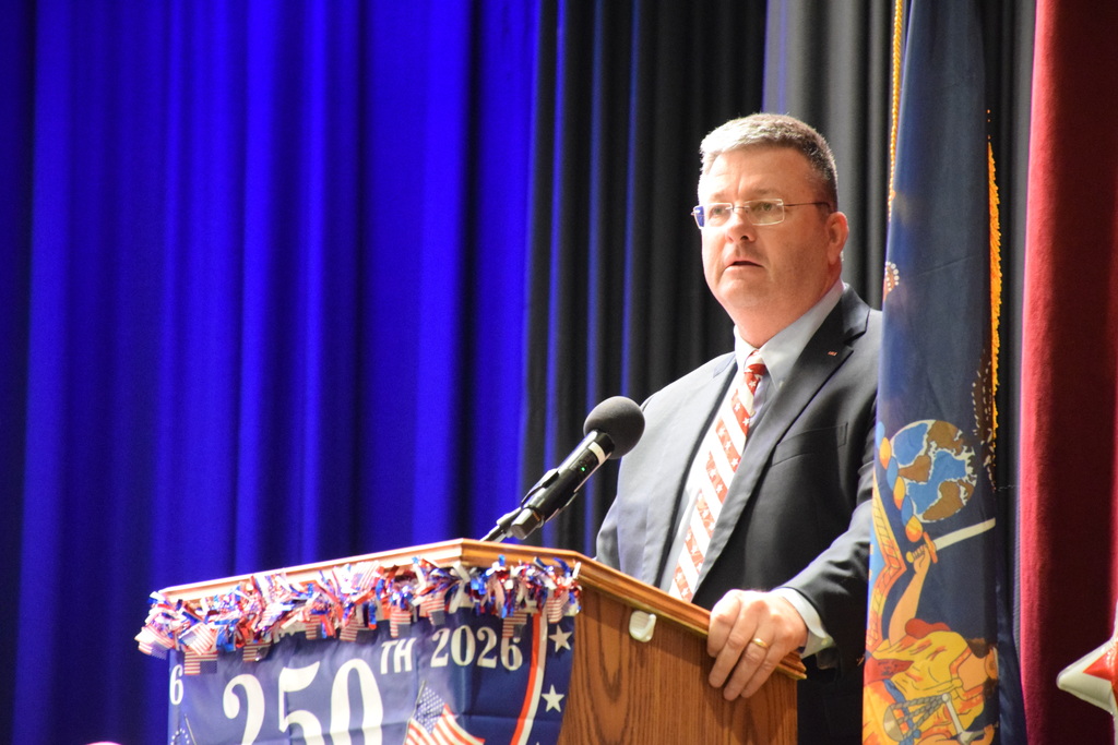 United States Navy Commander William Hesse, a member of the Locust Valley High School Class of 1984, spoke to current seniors about the symbolism of the Stars and Stripes.