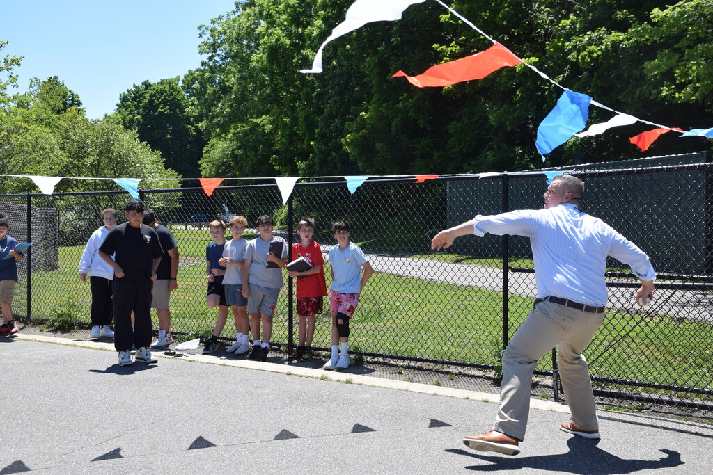 Principal Michael Cestaro takes his turn throwing at the "Can You Throw Faster Than a Sixth Grader" event.