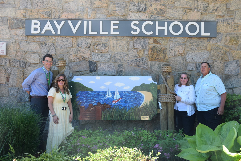 Bayville Primary School principal Ross Cohen and art teacher Jessica Cestaro celebrate the unveiling of the new mural in memory of former student Matthew Fetzer with his parents Ann and William Fetzer.