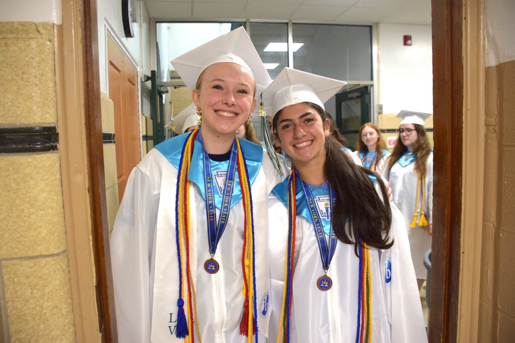 Two members of the Class of 2026 make their way through Bayville Intermediate School during their senior stroll.
