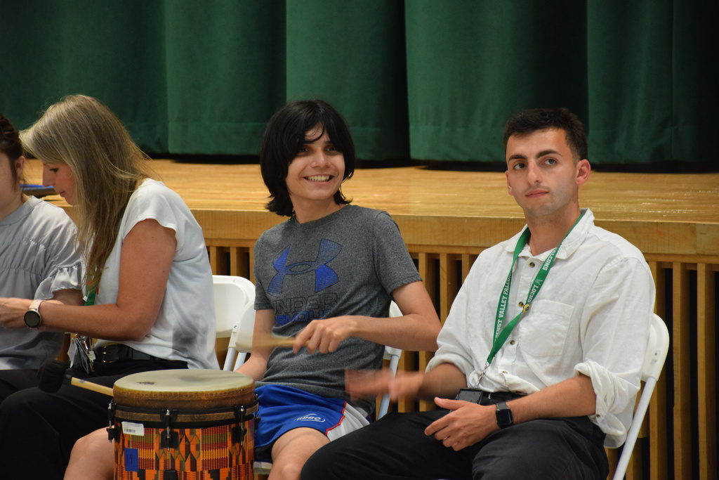A student drums at the music and art showcase 2026.