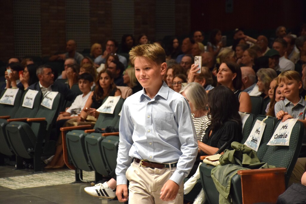 A LVI student walks up to the stage for fifth grade graduation.