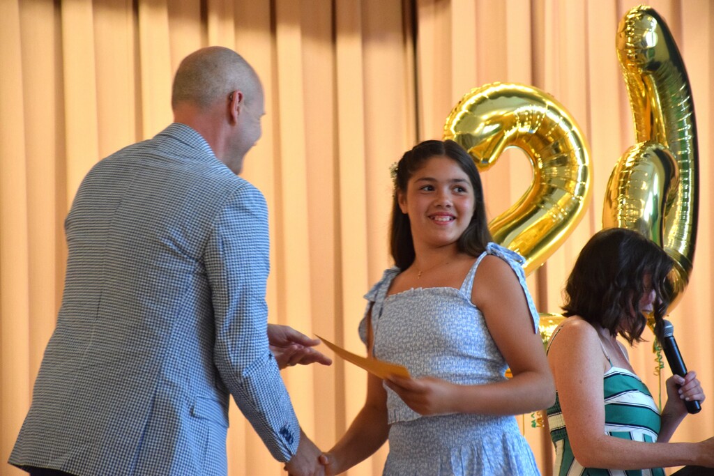 A Bayville Intermediate School student accepts her diploma as she heads off to sixth grade.
