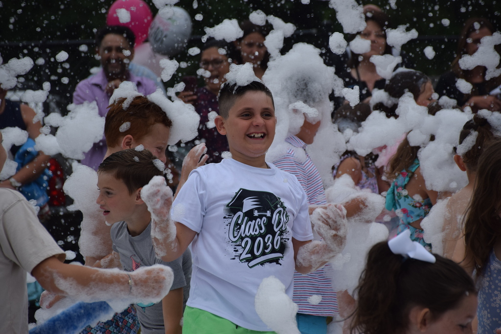A BP second grader enjoys the foam at the graduation party.