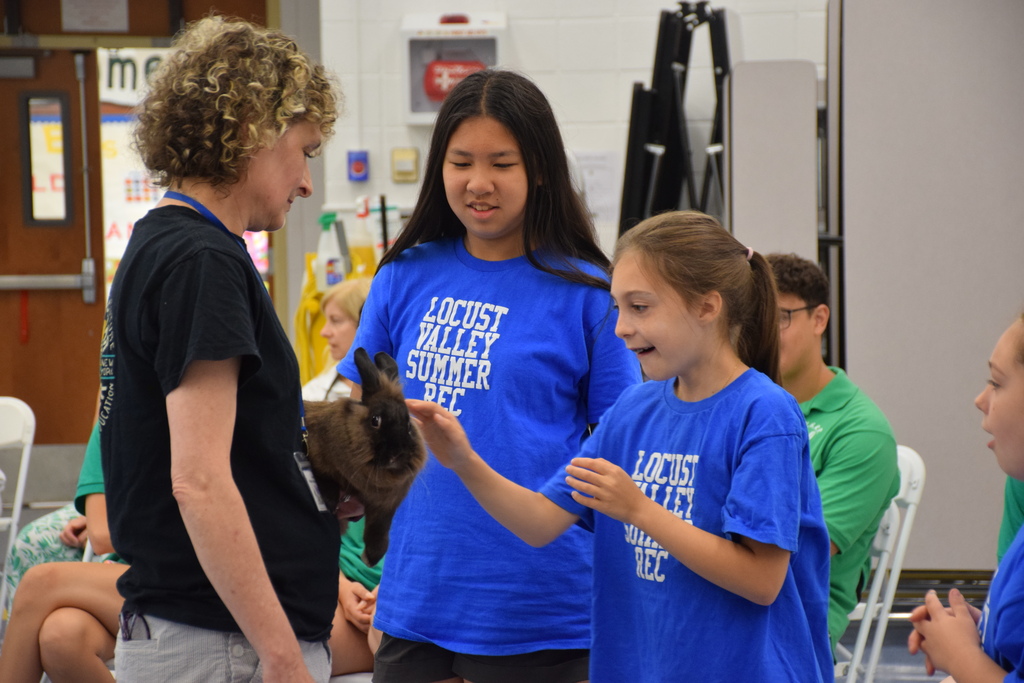 Summer recreation campers pet a rabbit from the Sweetbriar Nature Center.