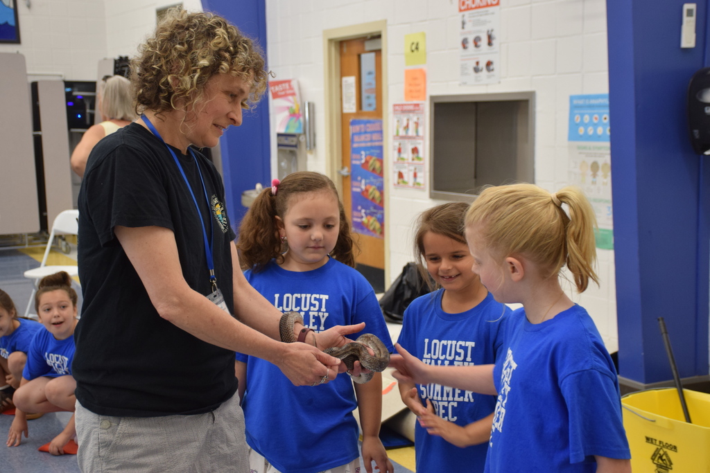 Summer recreations campers meet a snake from the Sweetbriar Nature Center.
