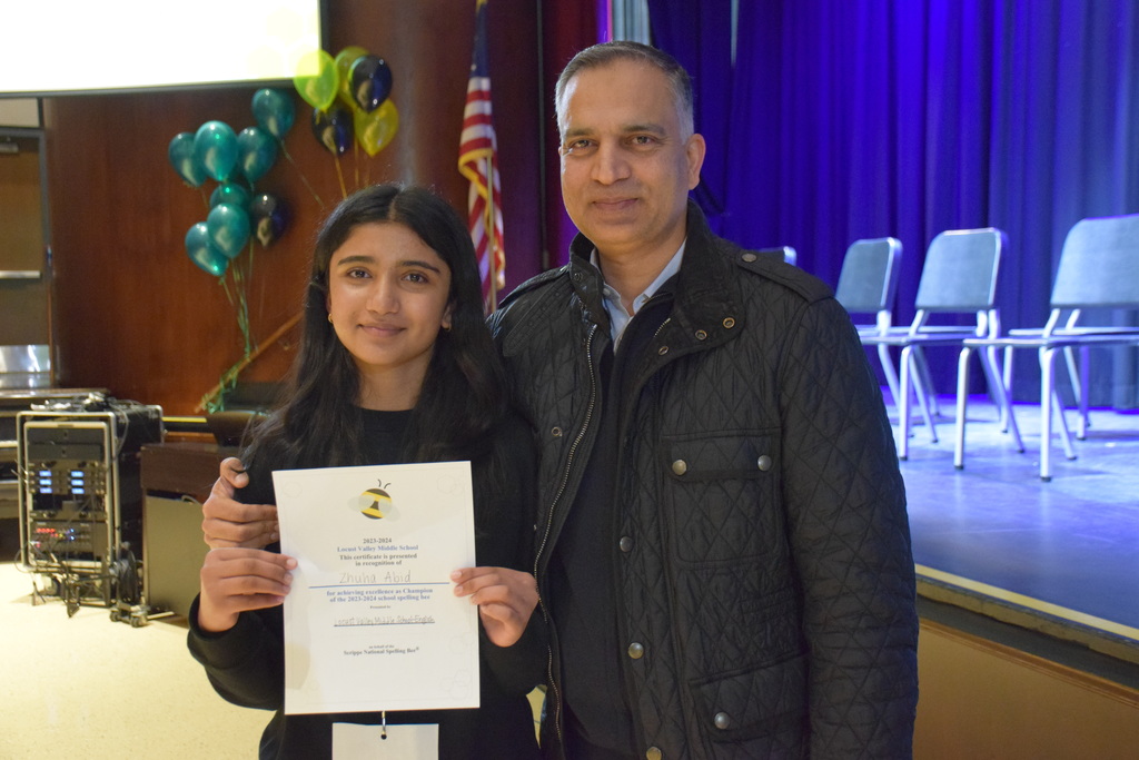 Seventh grader Zhuha Abid with her father after winning the Locust Valley Middle School Spelling Bee on Dec. 15.