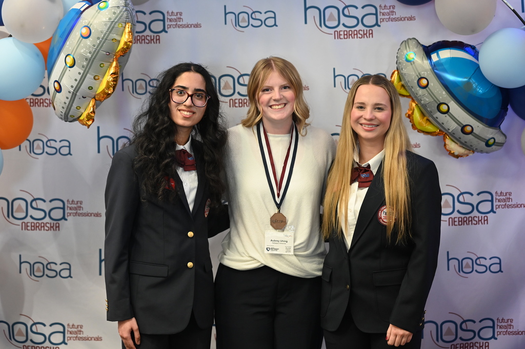 Aubrey Uhing receives her third-place medal in the Patient Care Technician event from Nebraska HOSA state officers.
