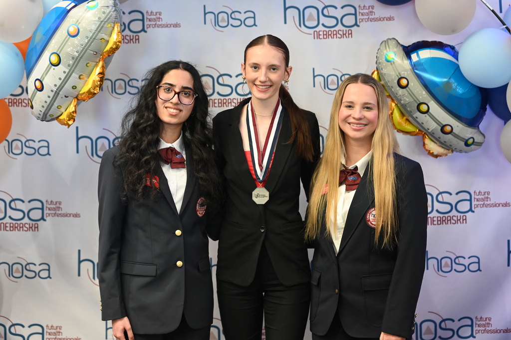Kinsley Mundil receives her second-place medal in the Patient Care Technician event from Nebraska HOSA state officers.