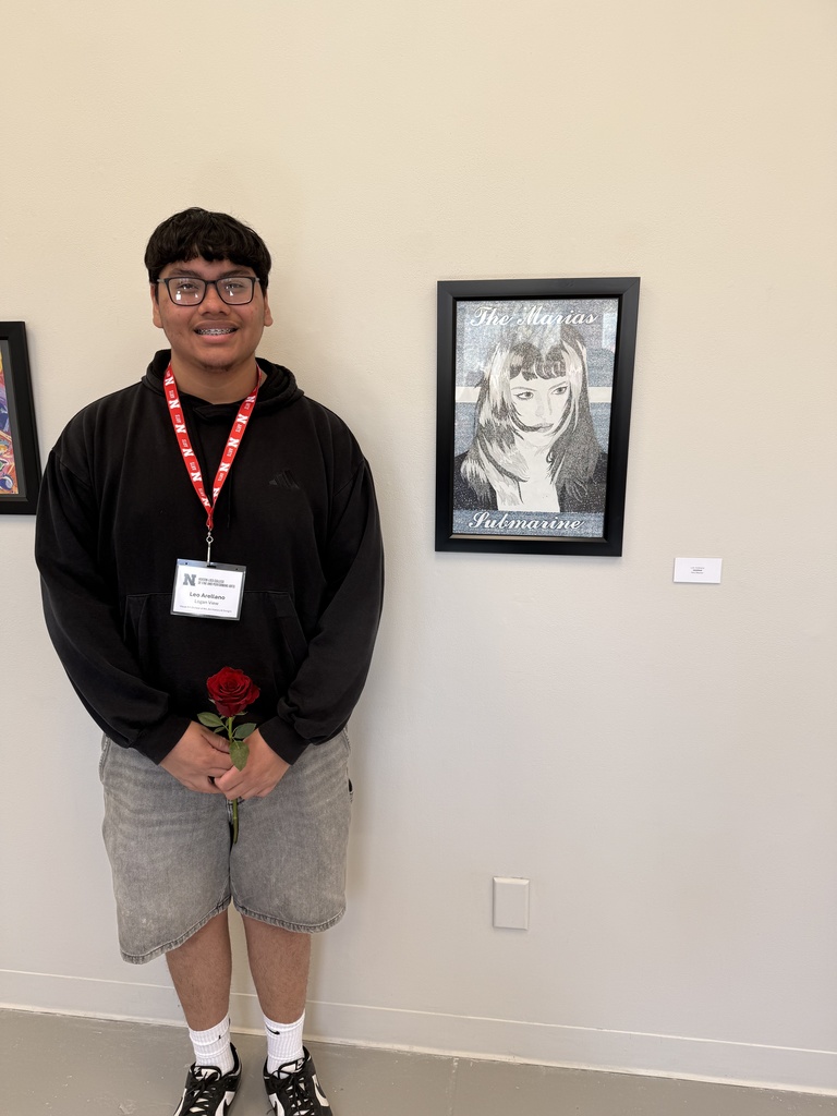 Leo Arellano standing by his artwork.