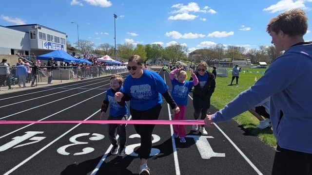 Students and helpers crossing finish line