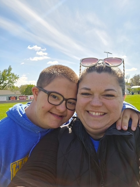student and helper smiling