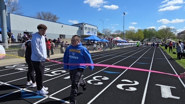 Student crossing finish line on track