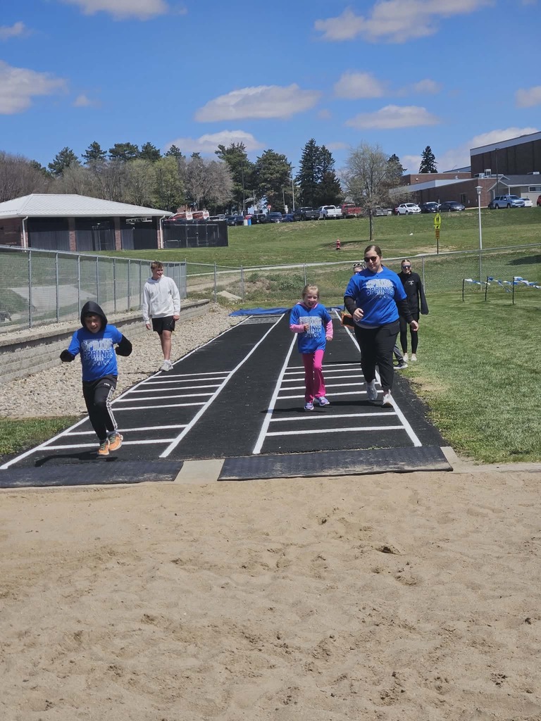 students and helpers participating in long jump activities