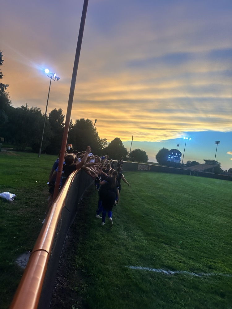 team celebrating with students vs NBC softball