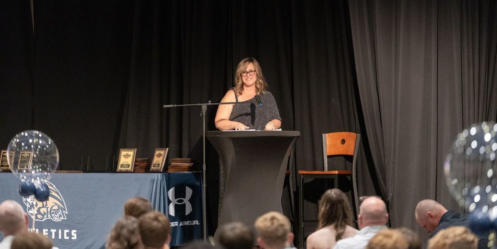 woman speaking behind podium