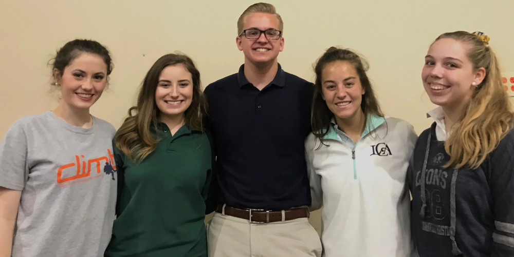 Five high school aged students pose for a photo smiling.