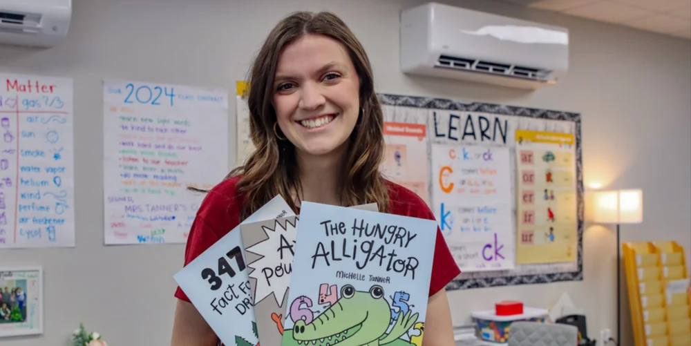 Michell Tanner poses with her three books she has written.