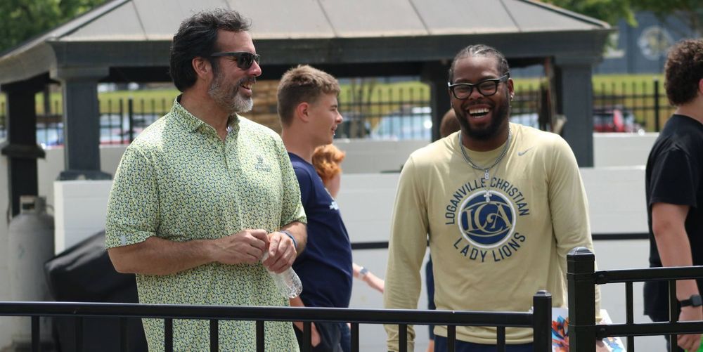 two men smiling and laughing