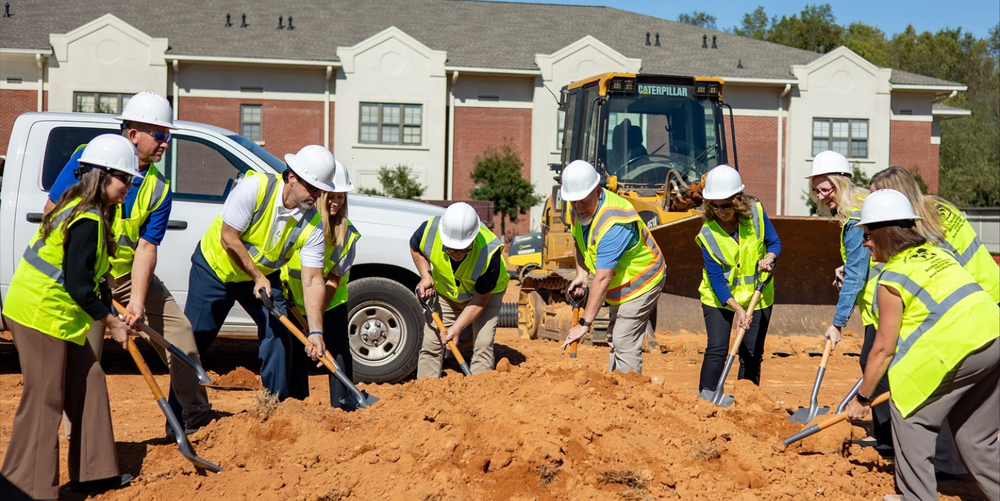 Loganville Christian Academy's Leadership Team participates in the groundbreaking ceremony by digging in with shovels. 