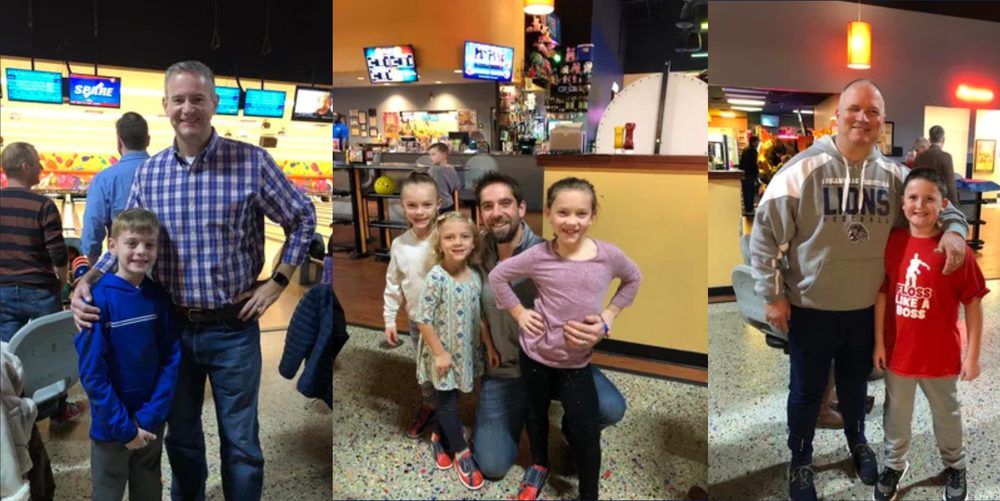A group of dads pose for photos with their children at a bowling alley.
