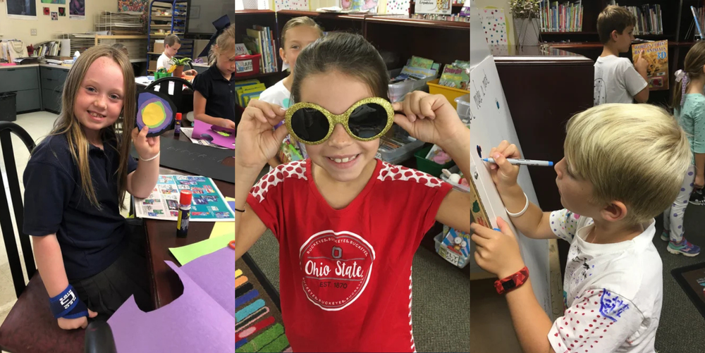 Three students show off their art projects on Dot Day.