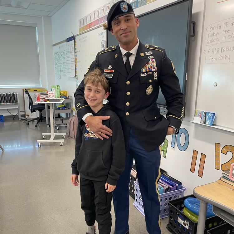 A man in uniform stands with his son