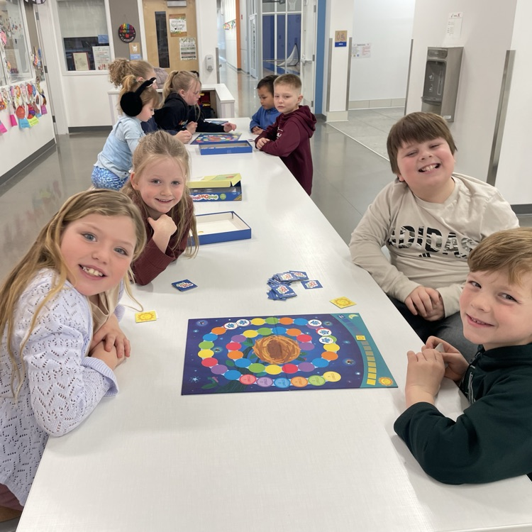 A group of students play a board game
