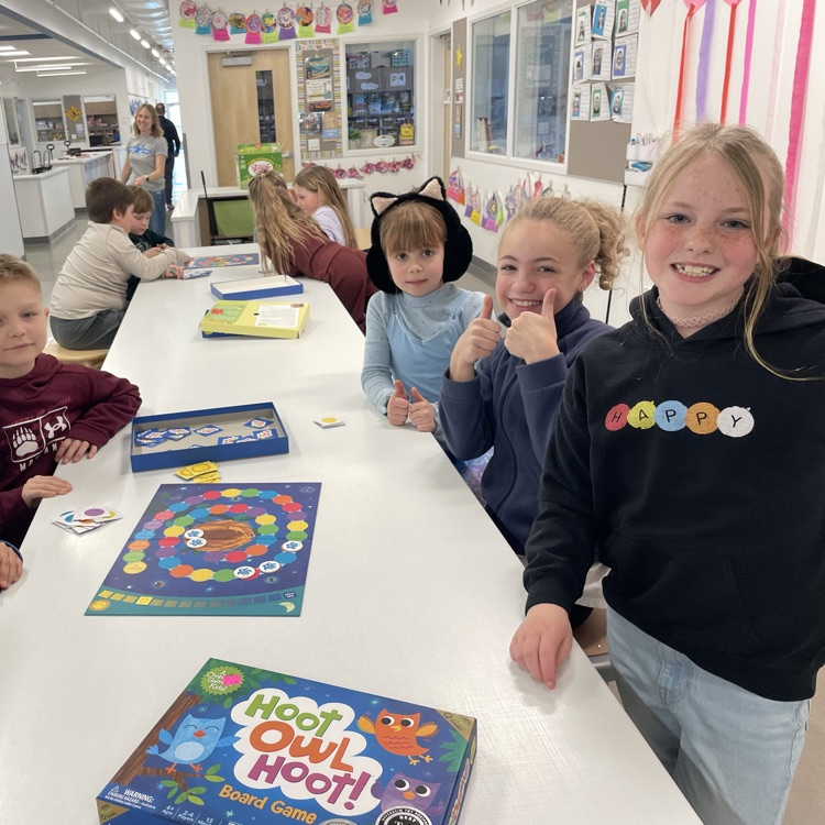 A group of students play a board game