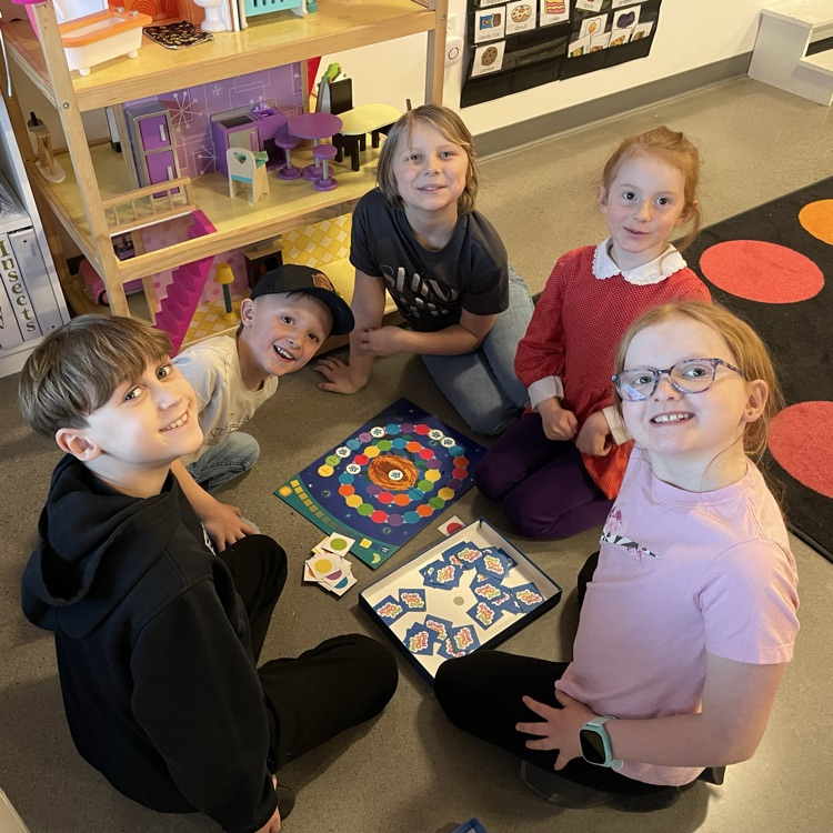 A group of students play a board game