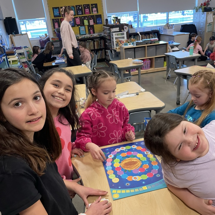 A group of students play a board game