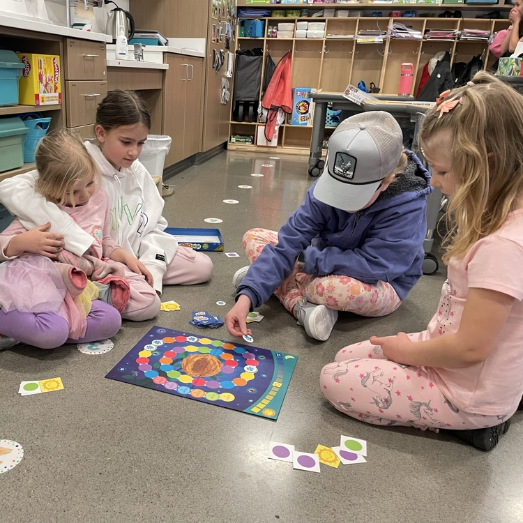 A group of students play a board game