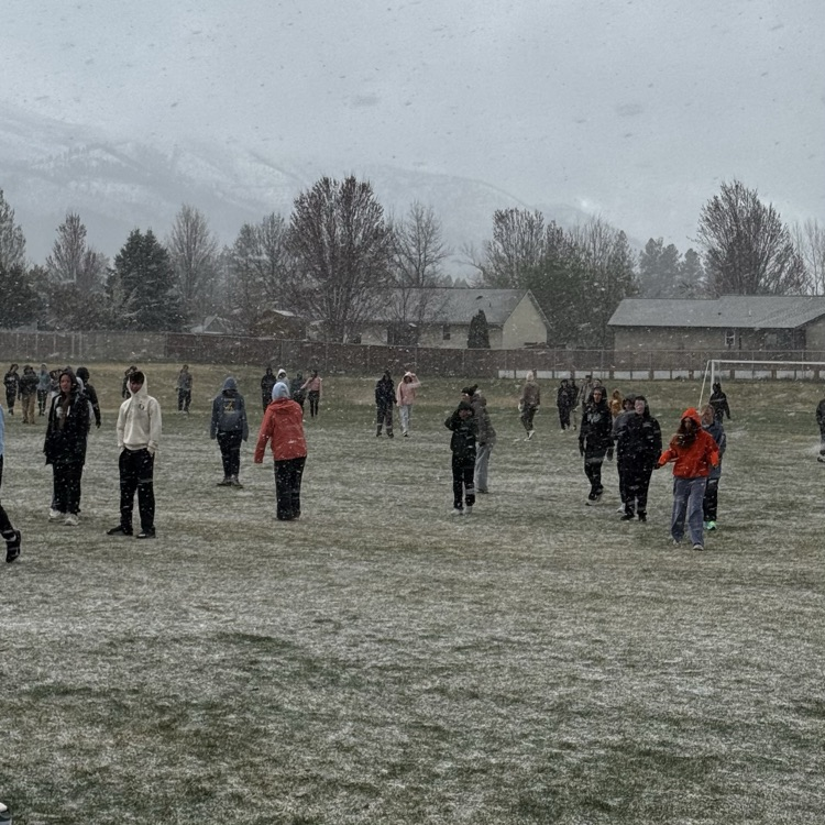 kids running track in the snow  