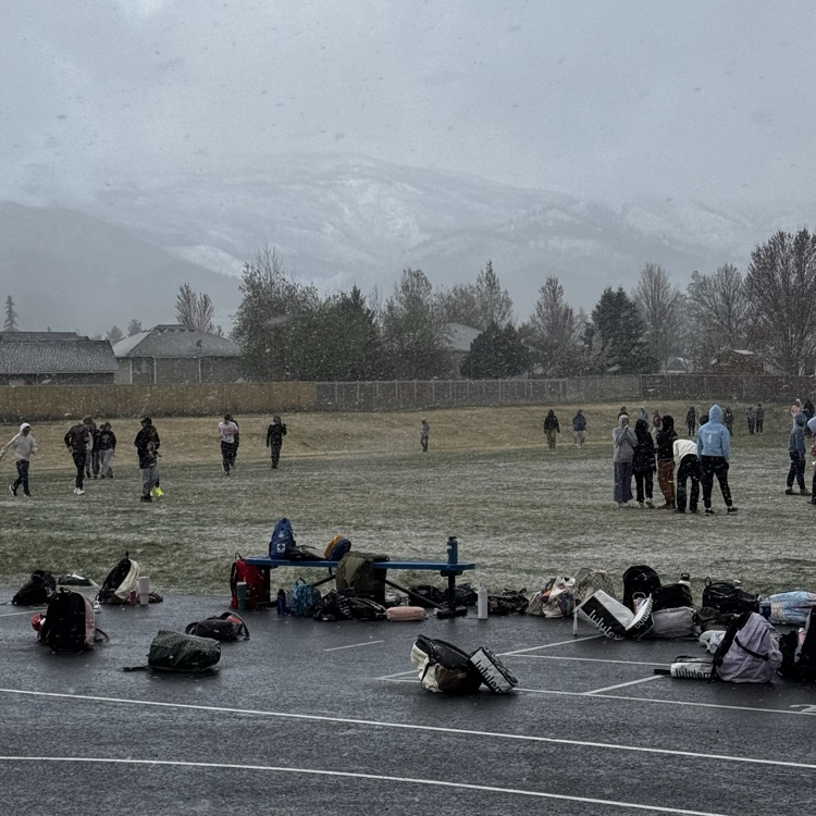 kids running track in the snow  