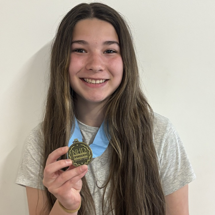 Harlow holds her NHD medal 