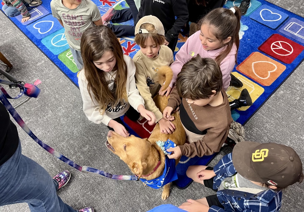 group of students with tan dog