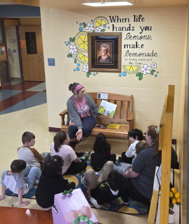 LES Paraprofessional Mrs. Byrd reads to students