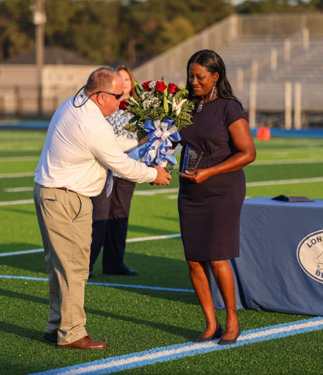 Mrs. Powell being presented with her System Teacher of the Year award by Superintendent Crane