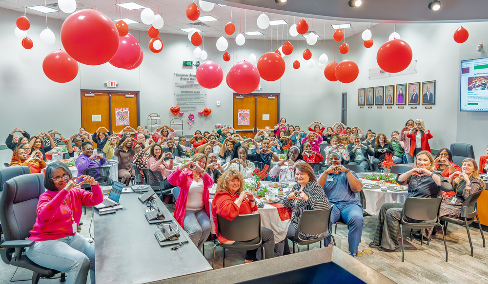 staff holding up hearts