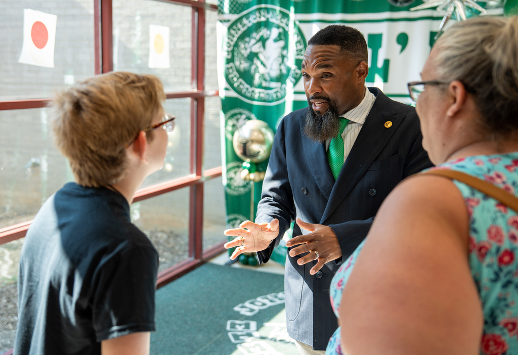 Dr. Walker welcoming a student at his campus.