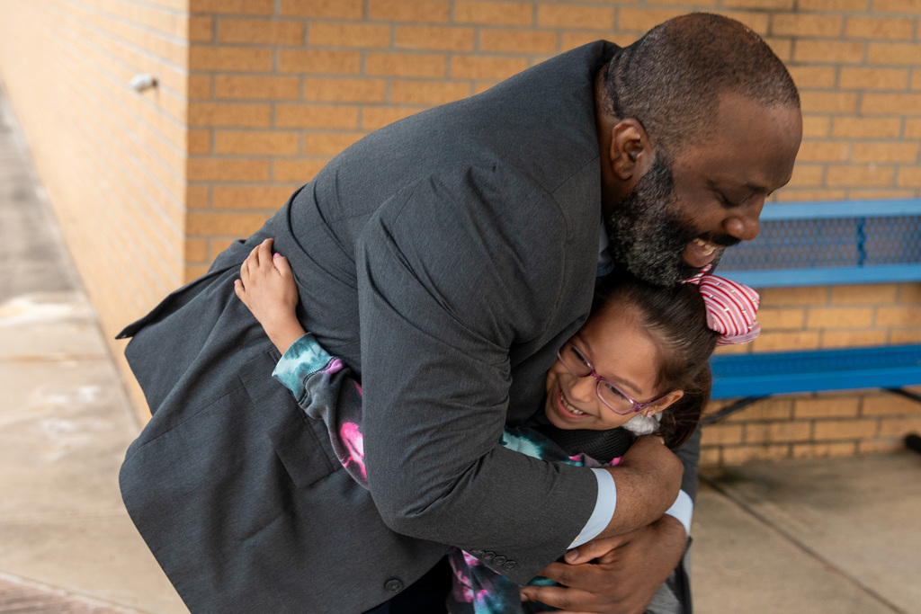 Dr. Estes greets a student on the first day of school
