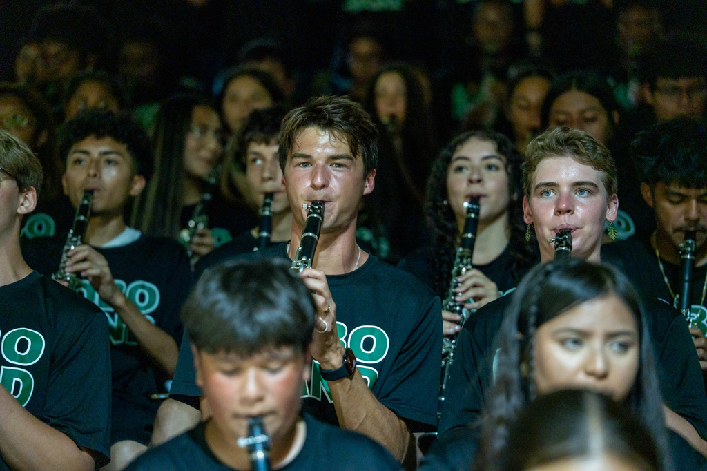 Band students playing the fight song on their clarinets.