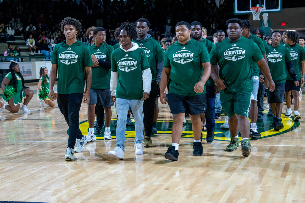 Football team walking through the rally line.