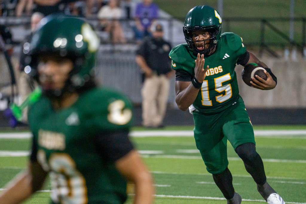 Longview quarterback running with the football.